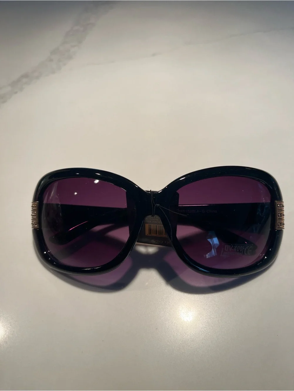 NWT fabulous oversized black sunglasses with gold tone design on front & sides.